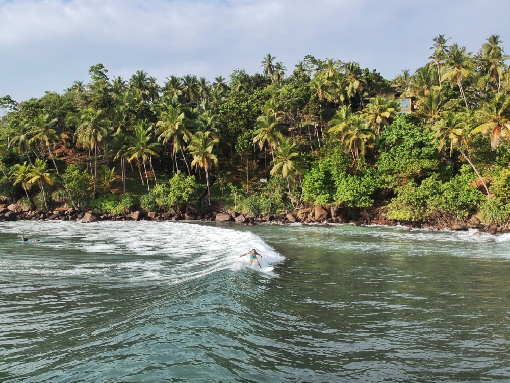 Surfer at Marissa beach in Sri Lanka